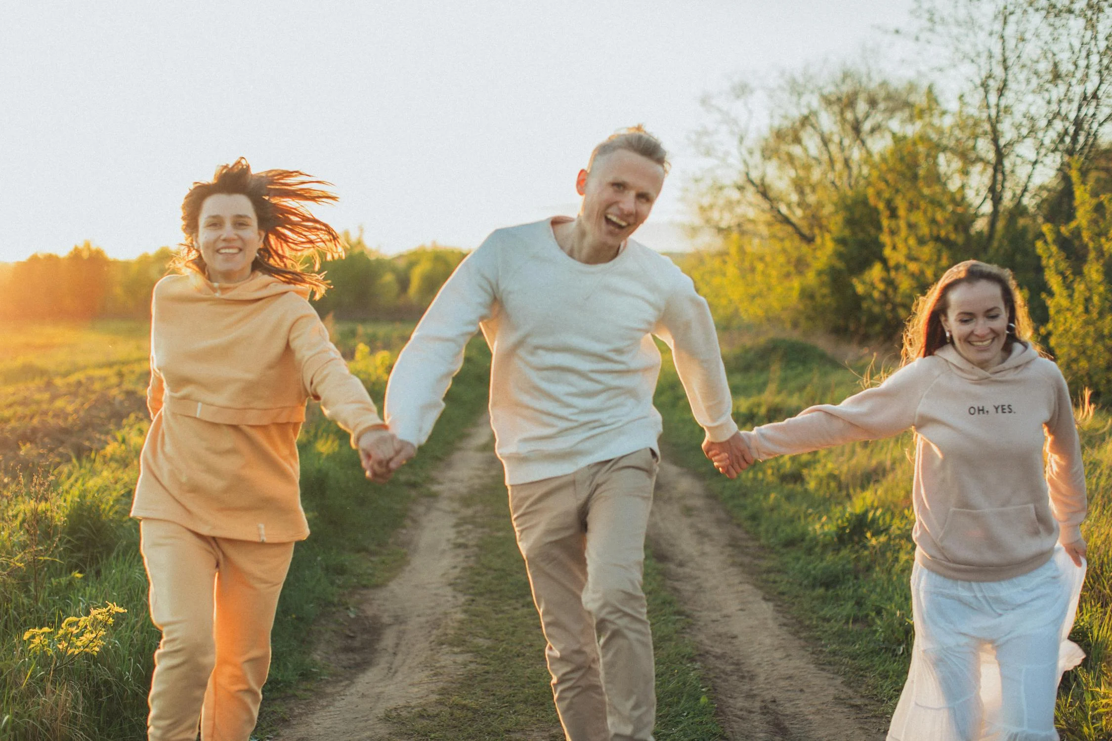 Family of 3 holding hands and jumping together